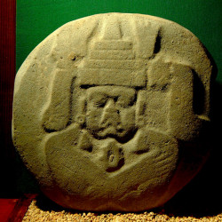 A large stone relief of a deceased man