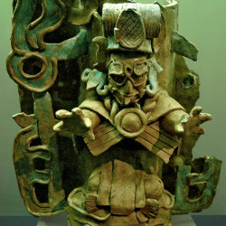 A fire-bucket from tabasco, featuring a priest standing on a mosquito head